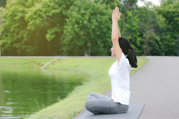 Femme qui s'étend avec une posture de yoga dans les concepts nature.health.