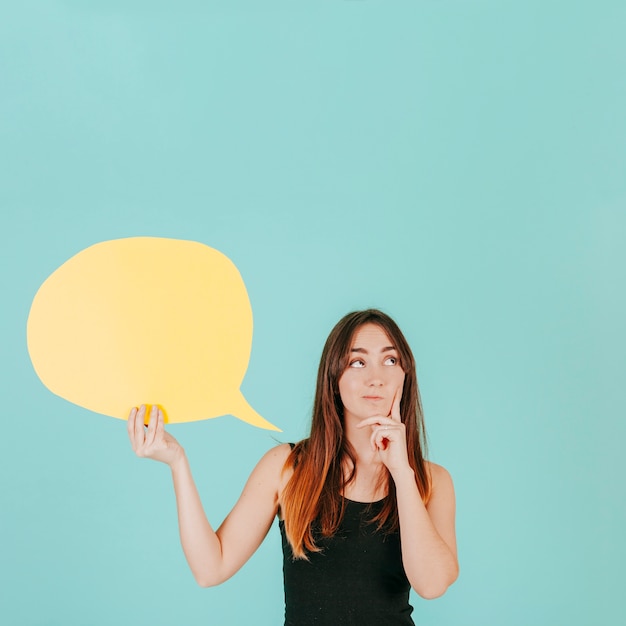 Photo femme réfléchie avec bulle de dialogue