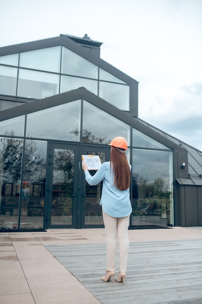 Femme regardant le bâtiment avec dos à la caméra