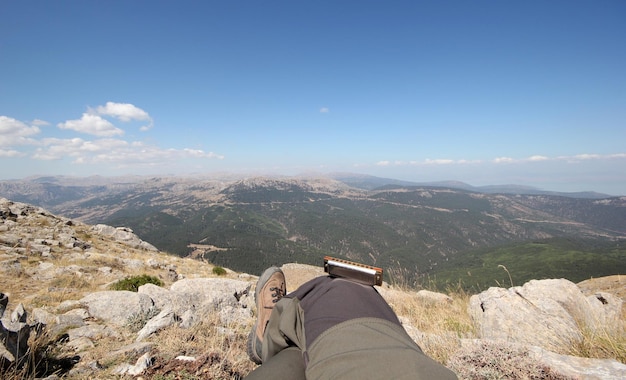 femme regardant la nature et son harmonica