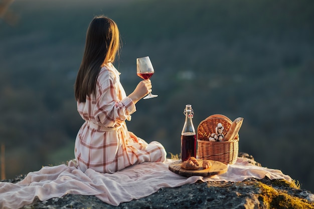 Femme relaxante dans la montagne au pique-nique