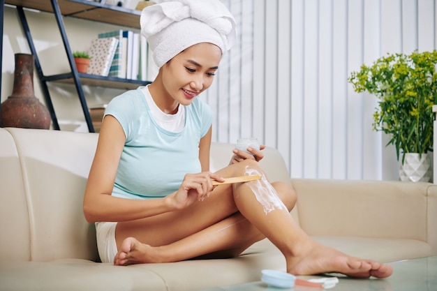 Femme remochant les cheveux à la maison