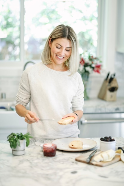 Femme, répandre, végétalien, fromage crème, sur, a, pain grillé