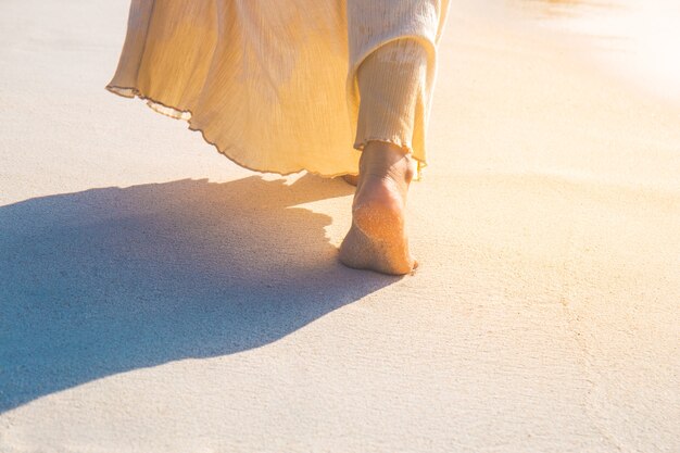 Femme en robe crème marche