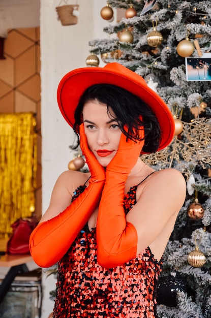 Femme en robe rouge et gants dans la salle du nouvel an