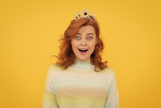 Femme rousse étonnée dans la surprise de la couronne de la reine