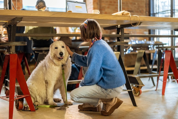 Photo la femme s'assied avec son chien au café moderne