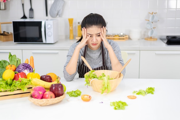 Femme s'ennuie dans la cuisine frustrée et endormie.