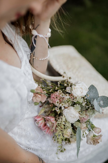 Femme avec un sac tissé plein de fleurs