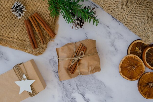 Photo femme se préparant pour les vacances de noël rédiger une liste de cadeaux boîte avec des cadeaux du nouvel an emballés dans de l'artisanat