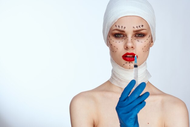 Femme avec une seringue injections de beauté portrait de beauté en studio sur fond blanc