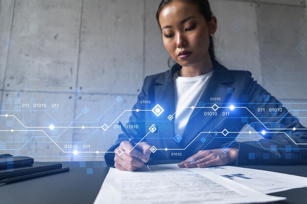 Une femme signe un contrat et un hologramme sur le thème de la technologie