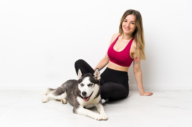 Femme avec son husky assis sur le sol