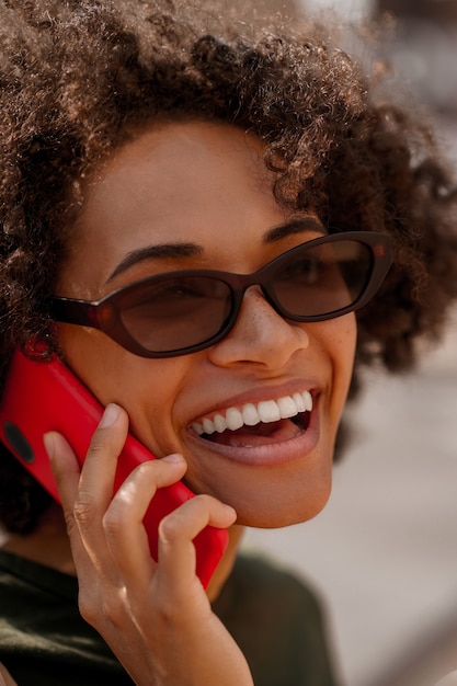 Photo femme souriante. une photo en gros plan d'une femme mignonne souriante parlant au téléphone