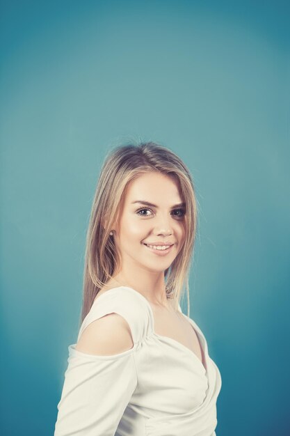 Femme souriante avec un sourire parfait et des dents blanches et regardant la caméra