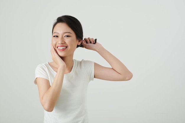 femme souriante, tordant cheveux