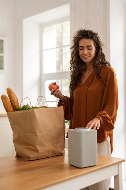 Photo femme souriante vue de côté avec des produits d'épicerie