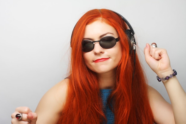 Femme de style rock avec un casque écoutant de la musique