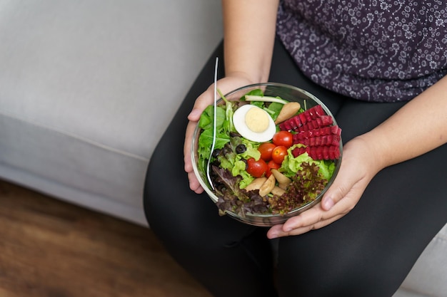 Femme en surpoids asiatique suivre un régime perte de poids manger des salades fraîches et fraîches faites maison concept d'alimentation saine