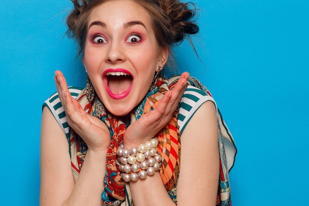 Femme surprise sur un mur bleu avec.