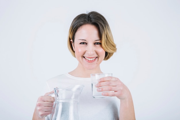 Photo femme sympathique avec verre et pichet