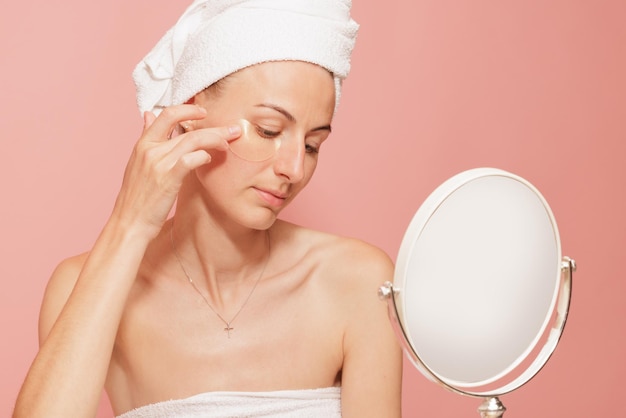 Femme avec des taches sous les yeux touchant sa peau lisse