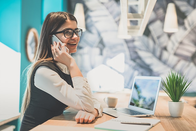 La femme téléphone au bureau