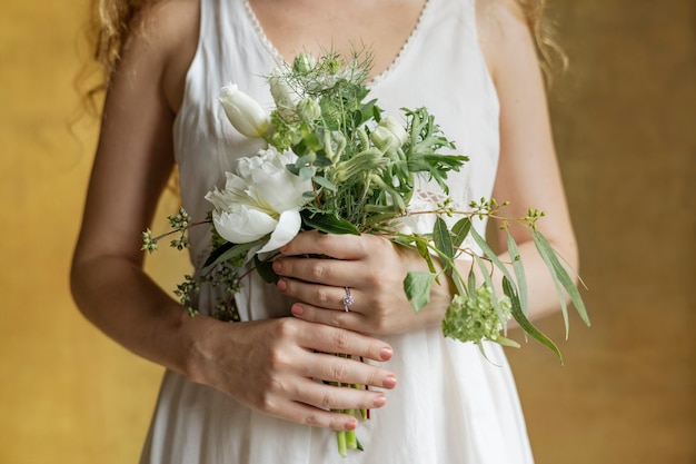 Femme tenant un bouquet de fleurs blanches