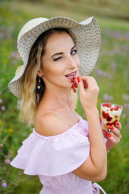 Une femme tenant un dessert aux framboises