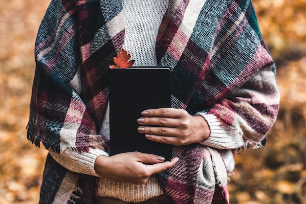 Femme tient un livre dans ses mains