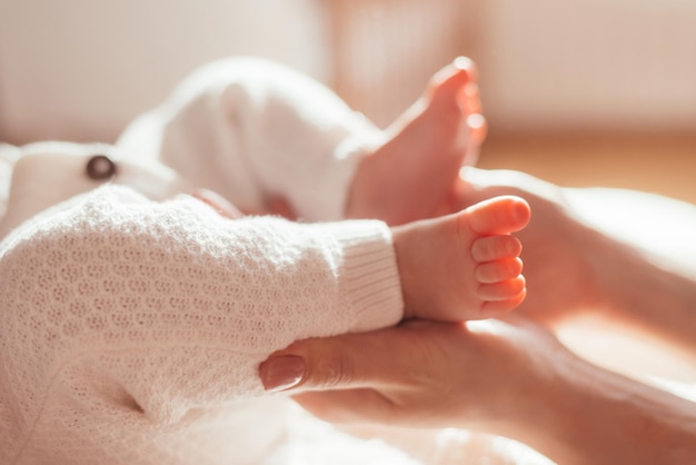 Femme touchant les pieds du nouveau-né avec les mains