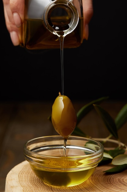 Une femme en train de verser de l'olive.