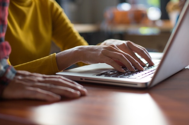 Femme travaillant au bureau à la maison la main sur le clavier