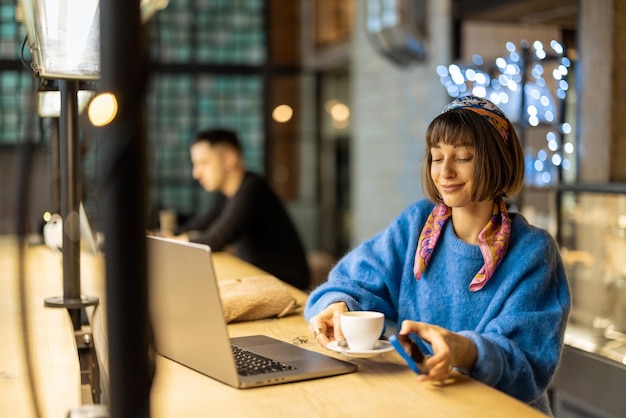 Femme travaille sur ordinateur portable au café