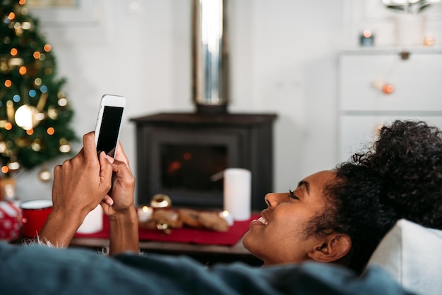 Femme utilisant un smartphone à Noël