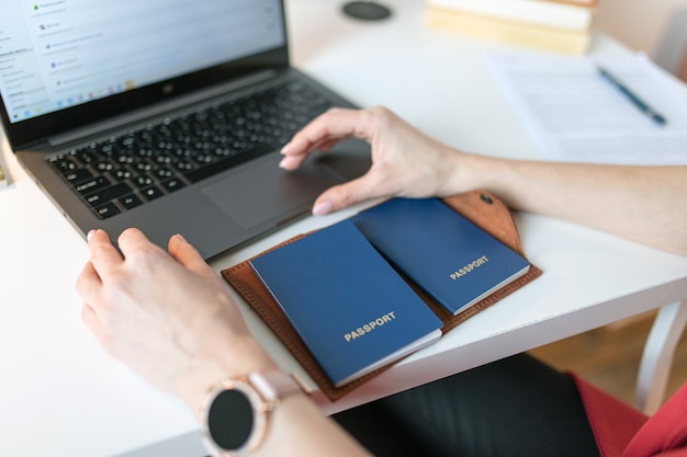 Une femme utilise un cahier pour réserver des billets d'avion et un hôtel pour un voyage. Concept de voyage