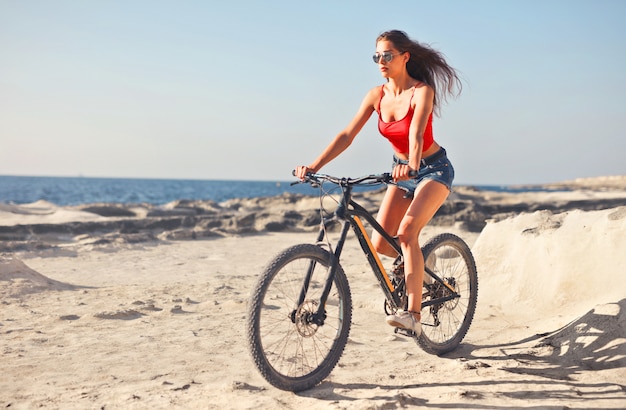 femme sur le vélo sur la plage