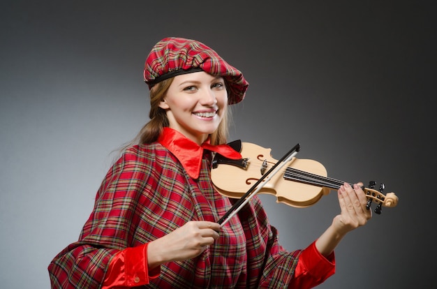 La femme en vêtements écossais dans le concept musical