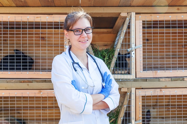 Femme vétérinaire avec stéthoscope sur grange ranch