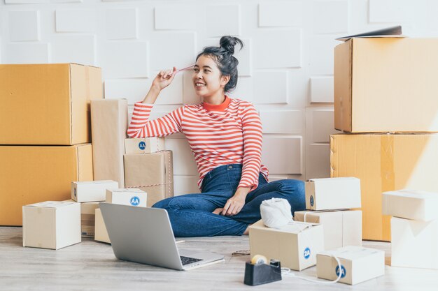 Femmes d'affaires asiatiques travaillant à la maison avec une boîte sur le lieu de travail