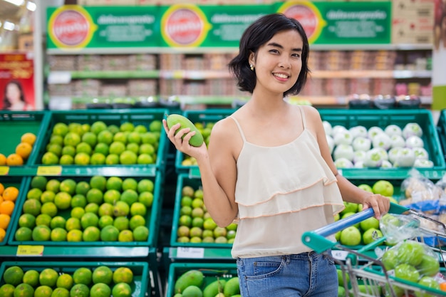 Les femmes asiatiques achètent des fruits et des légumes de supermarché.