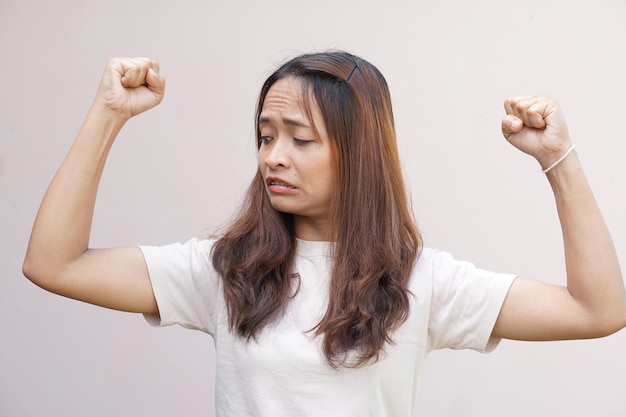 Les femmes asiatiques fléchissent leurs muscles et montrent leur force