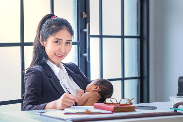 Femmes asiatiques travaillant dans les affaires et élevant des enfants à la maison