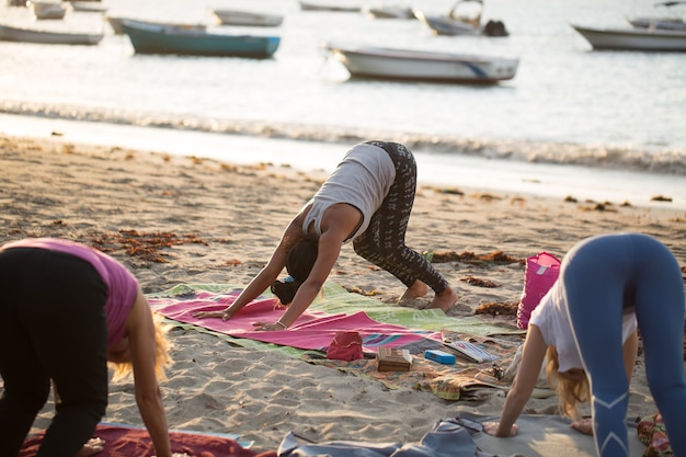 Femmes faisant des exercices de yoga ou pose de pigeon soutenu