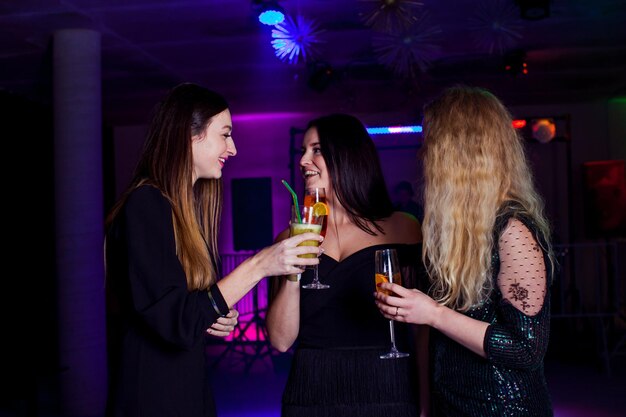 Les femmes s'amusent et boivent des cocktails avec des fruits