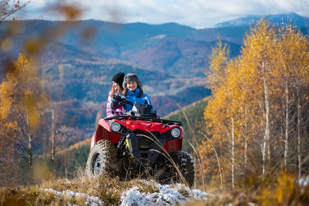 Femmes sur un VTT sur des collines enneigées