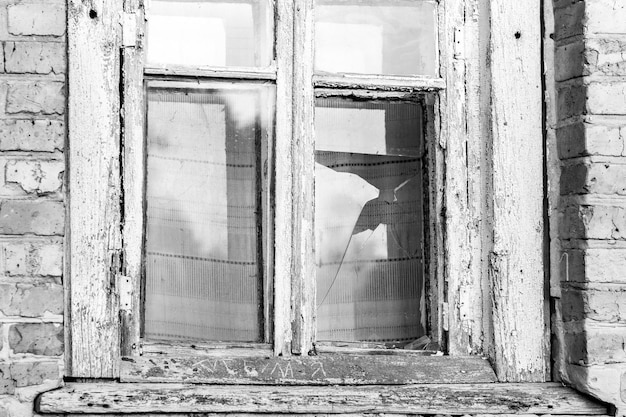 Fenêtre cassée d'une vieille maison abandonnée image en noir et blanc