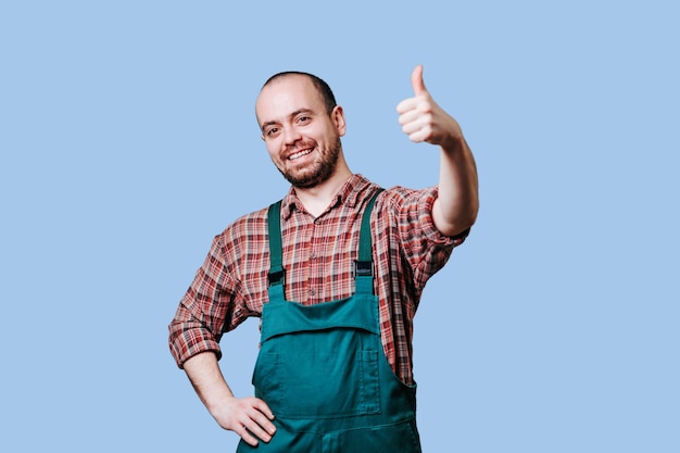 Fermier joyeux avec les pouces vers le haut et regardant la caméra