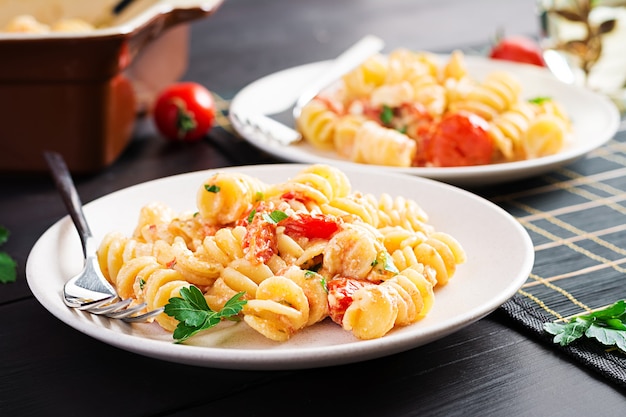 Fetapasta. Recette tendance de pâtes à la feta à base de tomates cerises, de fromage feta, d'ail et d'herbes. Réglage de la table.