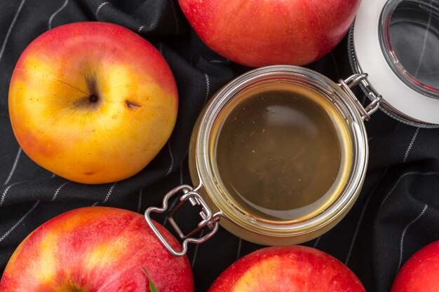 Fête juive de Rosh Hashana avec du miel et des pommes sur une table en bois.